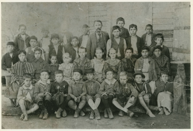 Photograph of Julian Gallardo, center, with students at El Carmen School, circa 1896