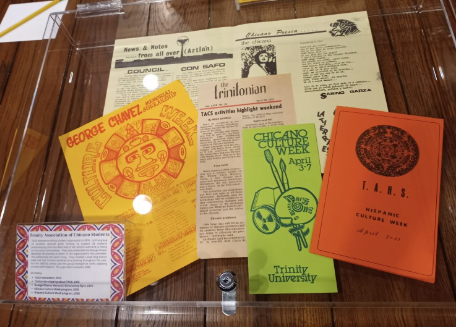 Display case of items from the Trinity Association of Chicano Students. Items are from the university archives.